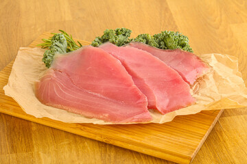 Raw salted tuna slice over board