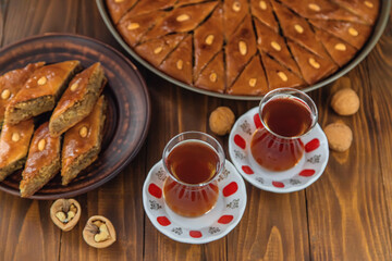 Baklava on the table and tea in Turkish glasses. Selective focus.