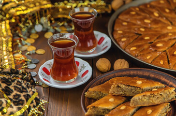 Baklava on the table and tea in Turkish glasses. Selective focus.