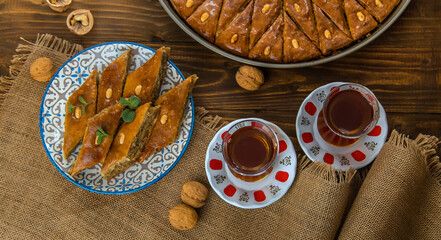 Baklava on the table and tea in Turkish glasses. Selective focus.