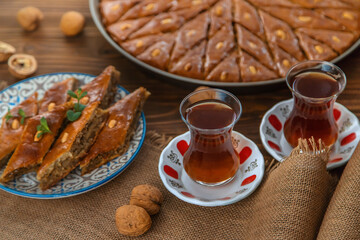 Baklava on the table and tea in Turkish glasses. Selective focus.