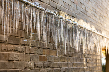 Icicles hanging on the home gas pipeline