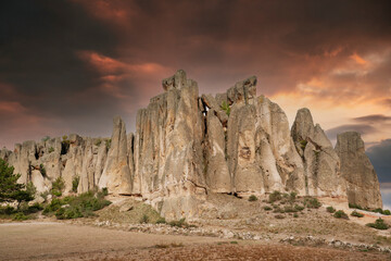 Historical ancient Frig vadisi (Phrygia, Gordion Valley). Houses, structures carved into rocks. Frig Valley is popular tourist attraction in the Ayazini, Afyon–Turkey. Sunset scenery in the background