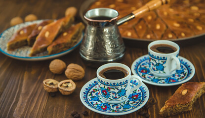 Obraz na płótnie Canvas Baklava on the table and Turkish coffee. Selective focus.