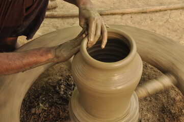 An Indian Artisan hands making clay pots 