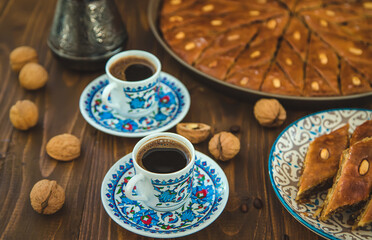 Baklava on the table and Turkish coffee. Selective focus.