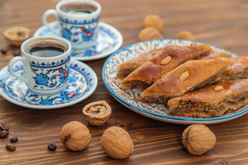 Fototapeta na wymiar Baklava on the table and Turkish coffee. Selective focus.