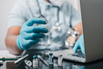 A doctor or scientist in the COVID-19 medical vaccine research and development laboratory holds a...