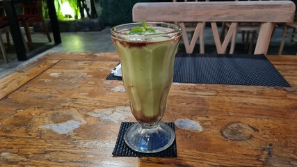 Green Smoothies in a glass cup, raw juice from natural vegetables and fruits