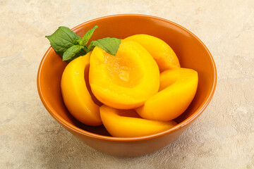 Sweet ripe canned peaches with mint