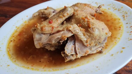 Nasi Ayam Bakar Taliwang or Grill Taliwang Chicken, is a traditional food from Lombok, Mataram Indonesia. Served with Plecing kangkung or water spinach. Top view.