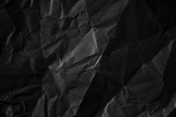 Textured crumpled black paper background.