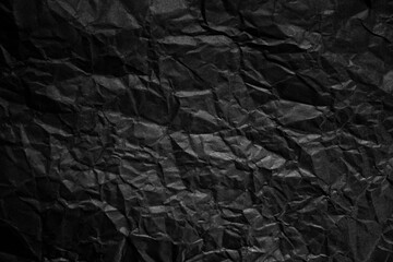 Textured crumpled black paper background.