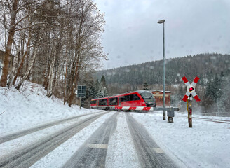 Train at a level crossing in winter