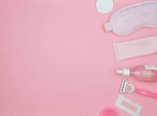 layout of items for face and body care on a pink background, cleansing gel, serum, face roller, guasha, razor, mask, cotton pad, balm, wax strip, pink, flat lay