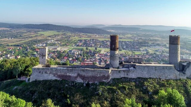 Medieval royal castle in Checiny near Kielce in Poland. Built in late 13th century. Ruin partly renovated. Aerial 4K approaching clip in sunrise light