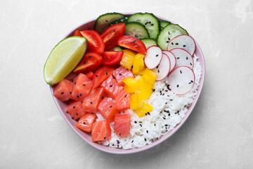 Delicious poke bowl with salmon, rice and vegetables on light grey table, top view