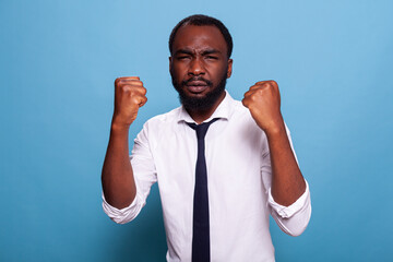 Portrait of motivated person fistfighting work problems having aggressive attitude. Defensive...