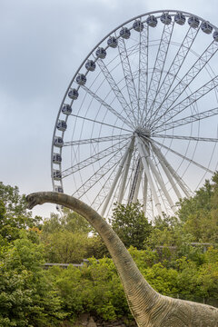Gothenburg, Sweden - May 2020: Ferris wheel and a statue of a dinosaur