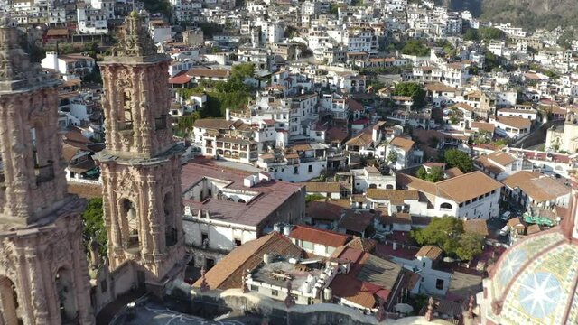 Aerial View of Taxco, Mexico. Flying Above Santa Prisca Church With Sunny Cityscape in Background - Drone Shot