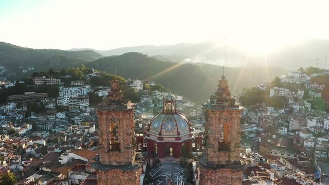 Aerial view of Santa Prisca Church in Downtown Taxco, Mexico on Sunny Morning, Colonial Landmark and Cityscape, Flying Above Drone Shot
