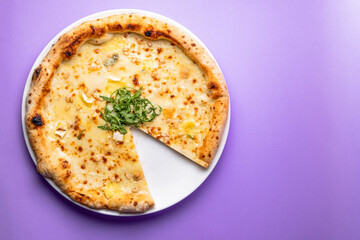 Tasty sliced pizza with fresh arugula and different kinds of cheese. Four cheese pizza, pizza Margarita.