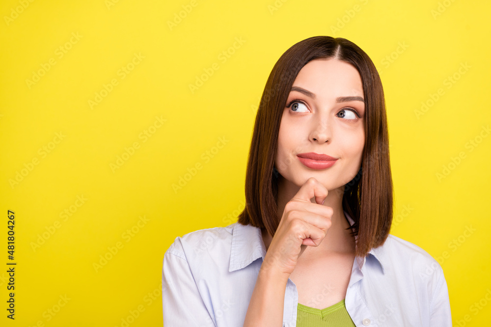 Wall mural Photo of lovely brunette millennial lady look empty space wear blue shirt isolated on yellow color background - Wall murals