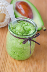 Fresh avocado puree in a small glass jar. Homemade face or hair mask, natural beauty treatment and spa recipe.