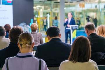 People gathering in modern hall during business forum