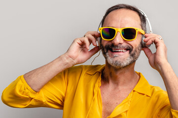 Stylish senior man peeking through sunglasses