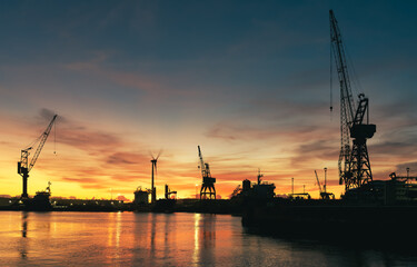 Silhouette of large industrial cranes International Container Cargo Port - Shipyards of Viana do Castelo, Portugal - Freight Transportation, Shipping - Landscape background