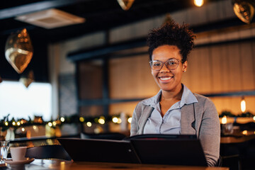 Fototapeta premium Portrait of smiling elegant woman, happy with her choice of food she ordered.