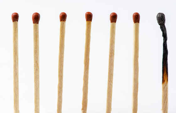 Burnt matches on a white background. The concept of burnout syndrome at work