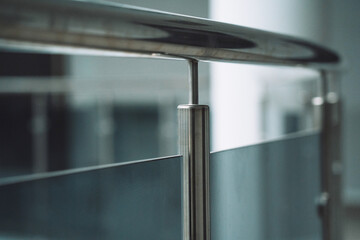 The railing element inside the business center is made of metal and glass.