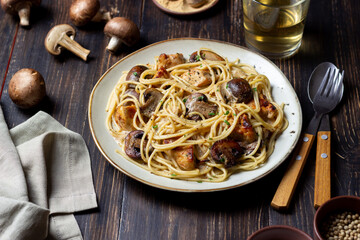 Pasta spaghetti in a creamy sauce with chicken and mushrooms. Italian food.