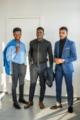 three african attractive males indoors in suits 