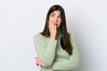 Young Brazilian woman isolated on white background is a little bit nervous