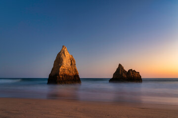 rock lit at sunset at Alvor beach, algarve, Portugal