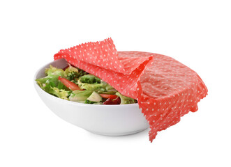 Bowl of tasty salad covered with beeswax food wrap isolated on white