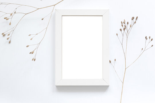 blank white photo frame with dry autumn flowers, art mockup