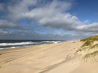 Fototapeta na wymiar scenic autumn sandy beach with waves and dunes in Sylt