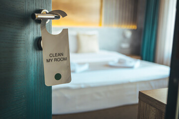 Please make up my room. Maid cleaning the room with please make up my room sign on the door. Opened door of hotel room in morning.Hotel, door open. Clean and elegant accommodation service.