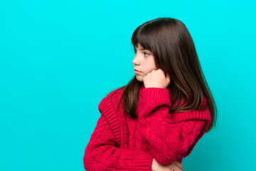 Little caucasian girl isolated on blue background with tired and bored expression