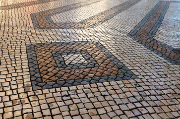 geometric detail worked with limestone and basalt on Portuguese sidewalks.