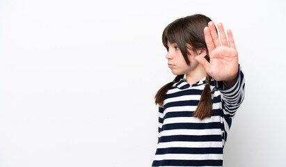 Little caucasian girl isolated on white background making stop gesture and disappointed