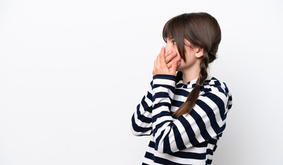 Little caucasian girl isolated on white background covering mouth and looking to the side