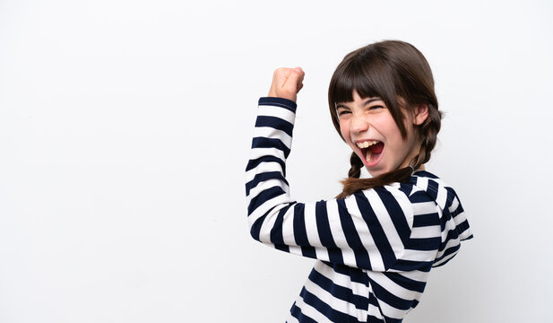 Little caucasian girl isolated on white background celebrating a victory