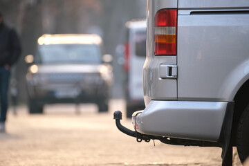 Close up of a van with tow hitch parked on city street side