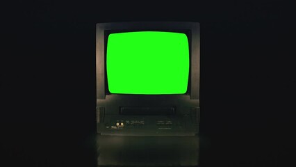 Vintage TV Green Screen in a dark room. Retro Television turning on with Noise and Static.