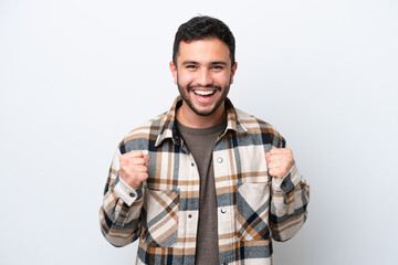 Young Brazilian man isolated on white background celebrating a victory in winner position